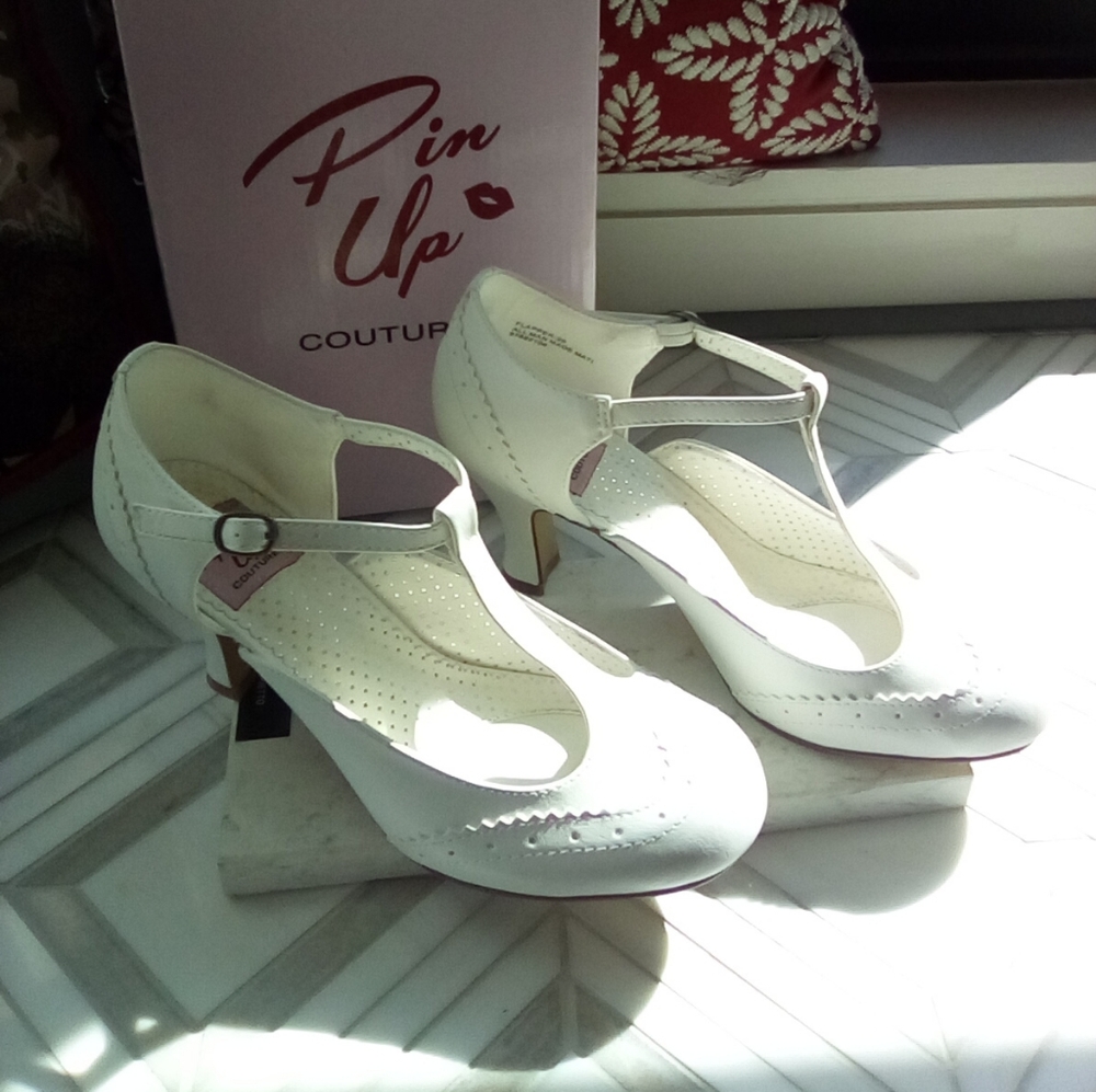 WHITE T_STRAP MARY JANE KITTEN HEELS. ALL MAN MADE MATERIALS.